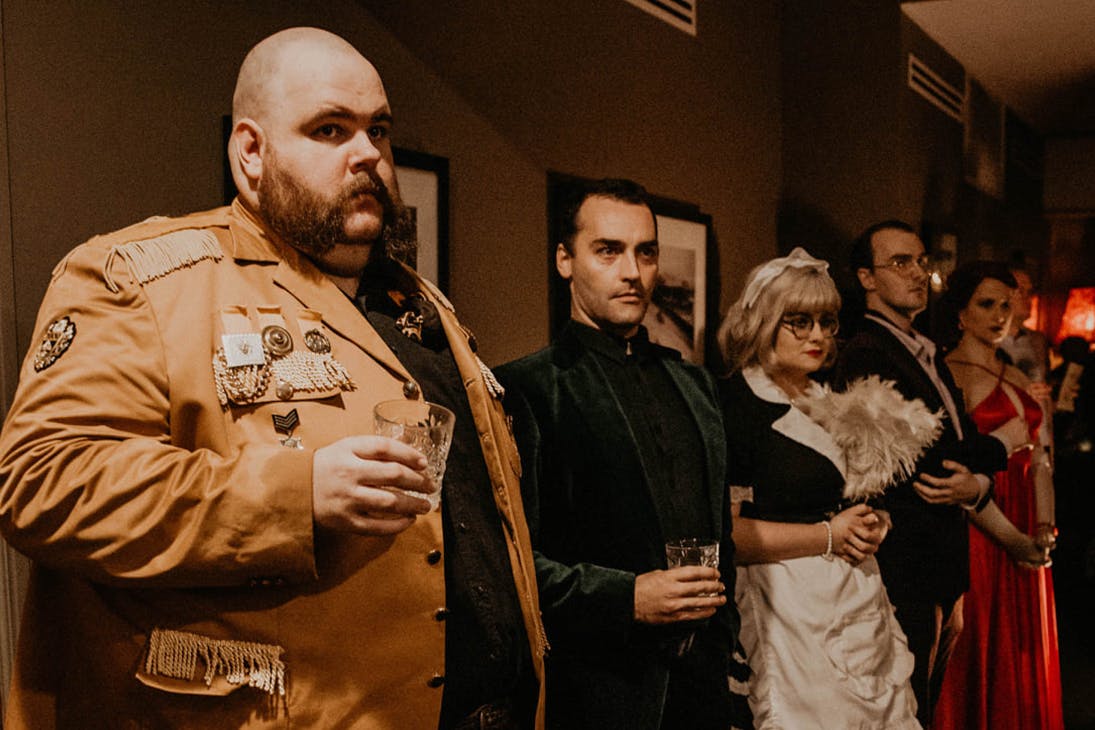 a row of people dressed as cluedo characters